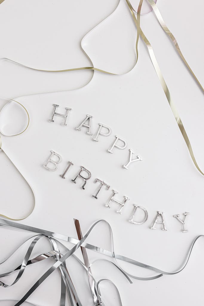 A Close-Up Shot of Plastic Letters and Ribbons